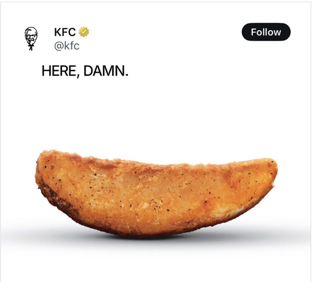 An Instagram post from KFC that says "Here, damn" next to a photo of their beloved potato wedges