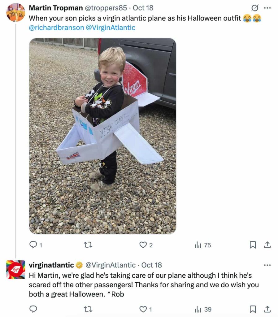 An X comment exchange on a post tagging Richard Branson and Virgin Atlantic about a kid wearing a Virgin Atlantic plane as a Halloween Costume. Virgin Atlantic quickly replied thanking the person for sharing and making a joke about scaring off the other passengers.